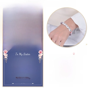 Detailed view of 8mm pink zebra stone bracelet with heart charm and gift card for daughter