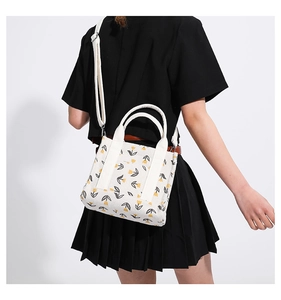 Detail of corduroy shoulder bag featuring yellow tulip prints on off-white fabric