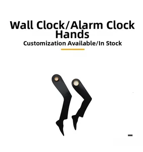 Macro detail of black boot-shaped clock hands with gold connector on white background