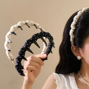 Padded white polka dot headband with non-slip teeth and twisted knot fabric design