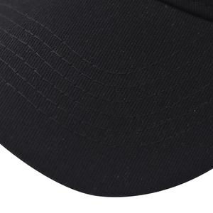 Macro view of parallel reinforced stitching on the black cotton twill baseball cap brim
