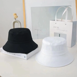 Japanese style wide brim cotton bucket hats in black and white with a minimalist aesthetic