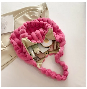 Detailed view of the fuchsia plush woven tote bag showing its storage capacity for essentials