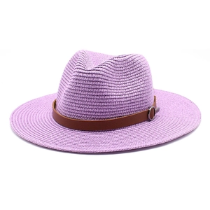 Macro detail of lavender woven straw sun hat with brown leather band and silver metal buckle