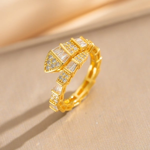 Gold plated snake ring with zircon inlay on luxury champagne silk background