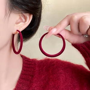 Elegant red velvet round hoop earrings shown worn on ear for a retro luxury look