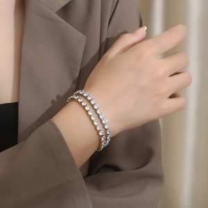 Close-up of silver and 18K gold plated titanium steel bracelets with pavé cubic zirconia