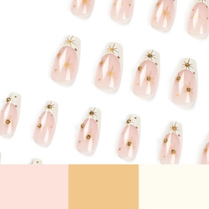 French tip press-on nails with naked pink base, gold star patterns and sparkling rhinestones