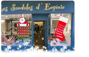 Felt Christmas countdown advent calendar with Santa house and sock designs in shop window