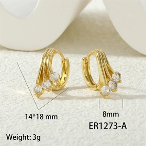 Detail view of gold hoop earrings with cubic zirconia stones showing 14x18mm dimensions