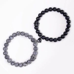 Detail of magnetic heart clasp on matte black and white marble beaded crown bracelets