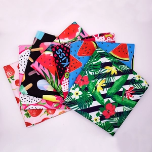 Detail view of assorted summer fruit prints on fabric pet bandanas and bibs