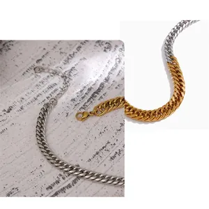 Detail of two-tone gold and silver stainless steel curb chain with lobster clasp and extender