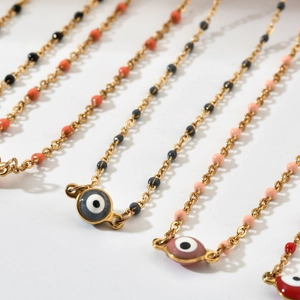 Golden Evil Eye necklace with colorful beads and enamel pendant on white background