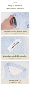 Detail of blue plush pet vest with white cloth label and curved hem for dogs