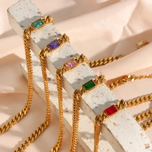 Detail of 6.5mm gold Cuban link necklaces with assorted colored rectangular gemstones