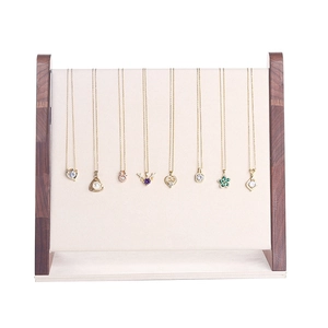 Walnut wood necklace display stand featuring various gold pendant styles and jewelry