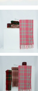 Close-up of wool-textured plaid scarves in various colors with decorative tassels