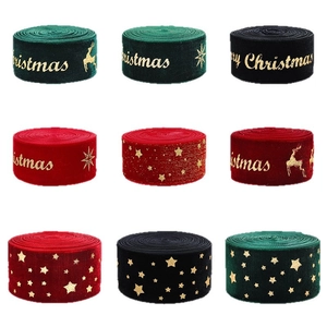 Nine rolls of velvet Christmas ribbons with gold foil patterns in red, green and black