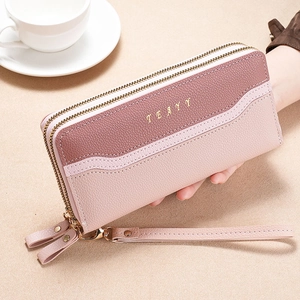 Close-up of double zip long wallet with pink lychee texture leather and wristlet