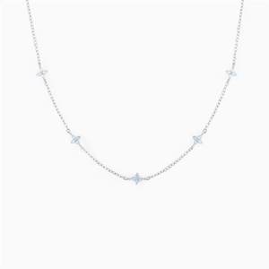 Detailed close-up of a silver necklace featuring five light blue zircon flower charms