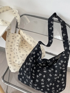 Floral canvas crossbody bag for women with wide strap and large capacity in black and white