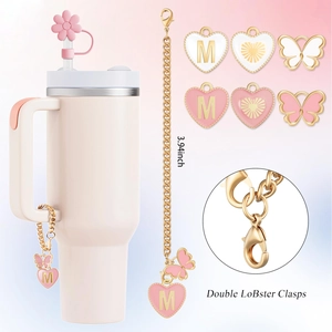 Pink straw cup accessory kit featuring heart and butterfly charms with golden chains
