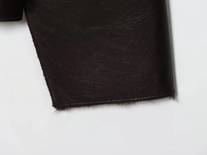 Vue macro du poignet d'une veste en similicuir foncé avec doublure en peluche