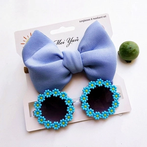 Kids blue bow headband and daisy round sunglasses set on display card for toddlers