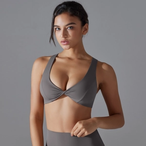 Close-up of dark grey yoga bra featuring a stylish front twist knot and wide straps