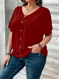 Elegant red V-neck short sleeve button blouse paired with blue denim jeans for women