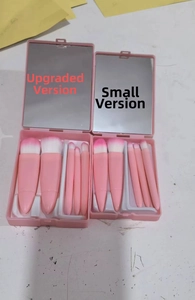 Macro detail of the 5-piece pink makeup brush set inside a storage case with mirror