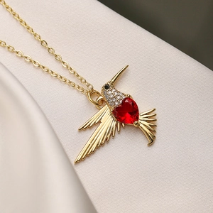 18K gold plated hummingbird necklace with a red heart-shaped zircon and pave crystals
