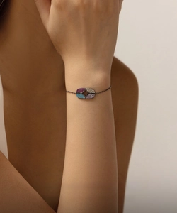 Detailed view of S925 sterling silver dark bracelet with multi-color star gems on a wrist