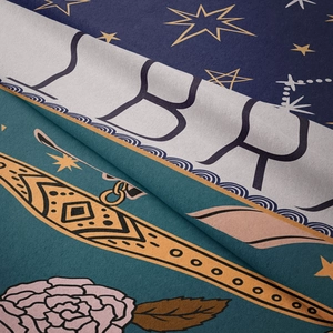 Close-up of soft printed tapestry fabric showing Libra zodiac design and floral details