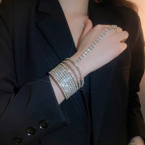 Detail of silver multi-layer rhinestone hand chain bracelet with elegant ring attachment