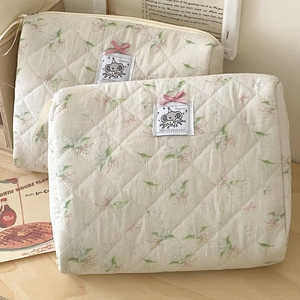 Quilted makeup bag set with floral print and pink bow detail in cream white