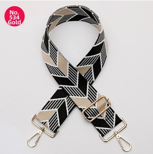 Close-up of No.534 woven strap with gold metal buckles and black-beige geometric patterns