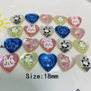 Flat lay of 18mm heart-shaped resin cartoon charms featuring animals for DIY crafts
