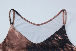Detailed close-up of brown leopard print fabric and stitching on women's slip dress