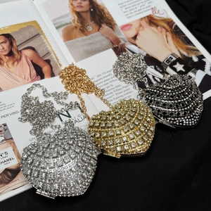 Heart-shaped crystal evening bags in silver, gold and black with chain straps