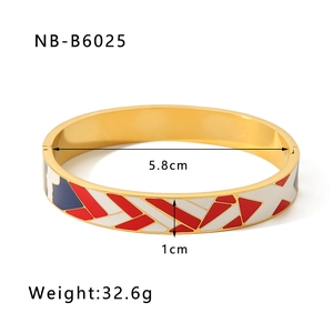 Detail view of 18k gold plated bangle featuring colorful red white and blue enamel patterns