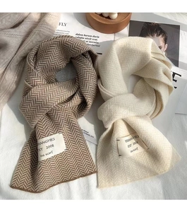 Vue détaillée des écharpes tissées à chevrons marron et beige avec étiquettes de marque