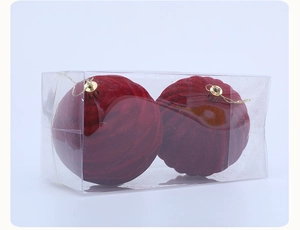 Close-up of wine red flocked Christmas balls with wavy texture and gold hanging strings
