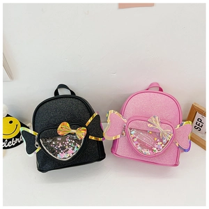 Detail of pink and black sequin backpacks featuring laser bow and clear heart window