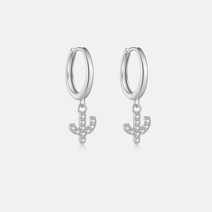 Close-up of silver cactus pendant earrings with sparkling white cubic zirconia stones