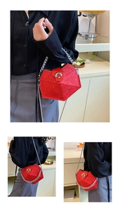 Detail view of red rhombic quilted shoulder bag with silver chain and metal buckle