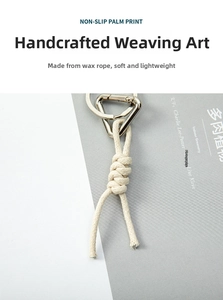 Close-up of cream white hand-woven rope keychain with silver metal clip and key ring