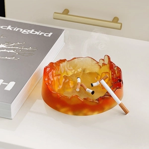 Artistic amber mountain peak resin ashtray shown in a modern home office setting