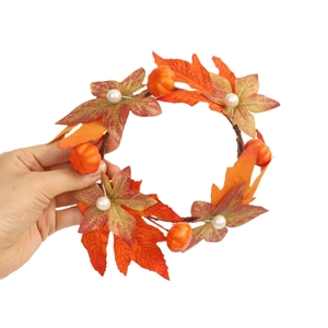 Autumn candle ring with orange maple leaves, mini pumpkins and white pearls for decor